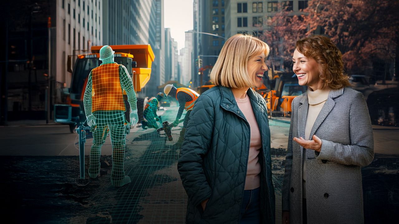 Two women on the street talking near sme roadworks