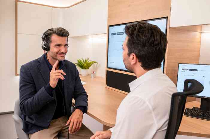 Male client going through hearing test with male audiologist