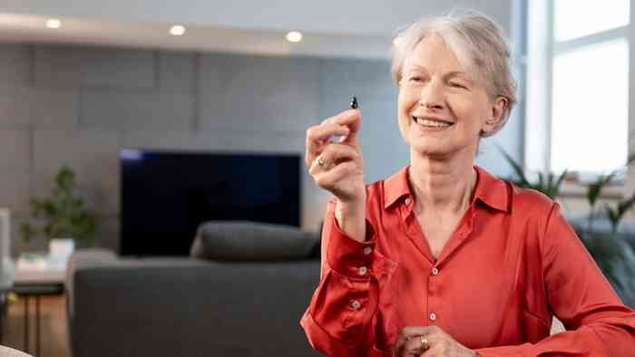 man on sofa with hearing aids
