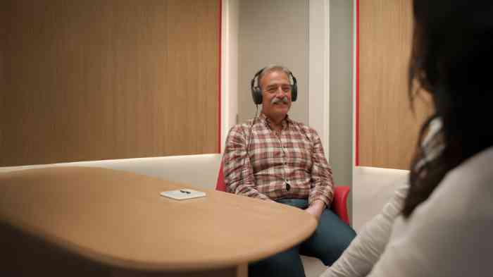 a couple hiking a mountain on a sunny day