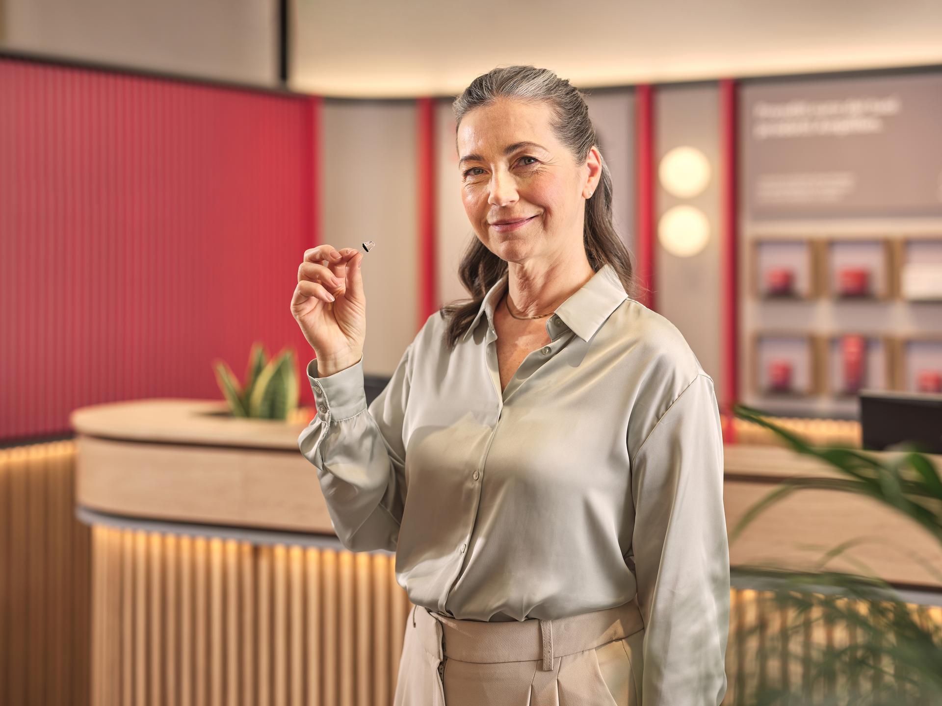 Audiologist holding a hearing aid 