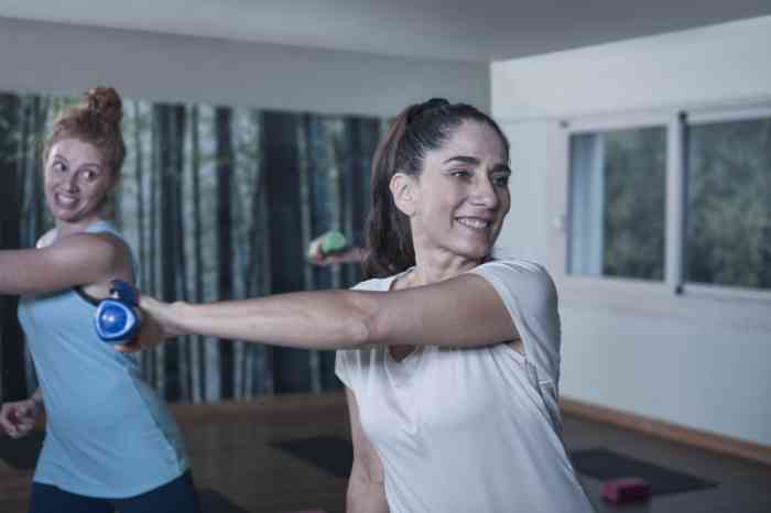 Two girls doing sports at home