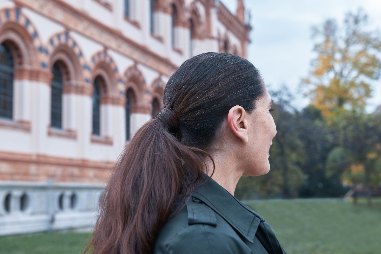 A woman in profile outside