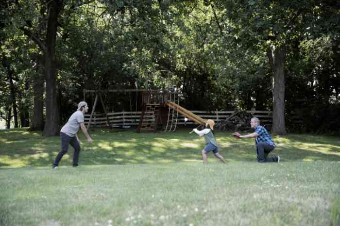 People of different ages playing baseball in the garden