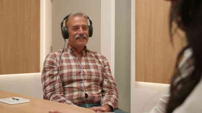 John having a hearing check