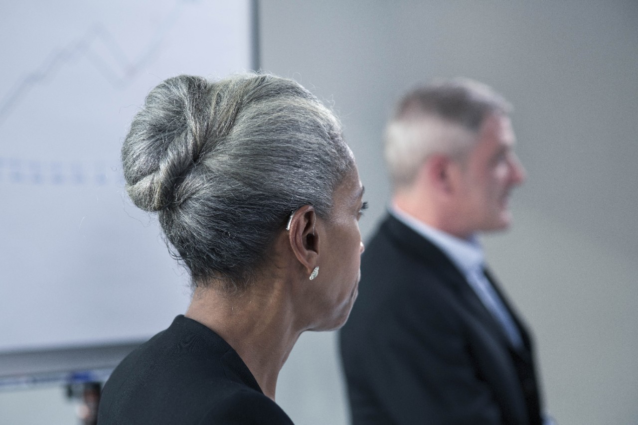 A business woman with hearing devices