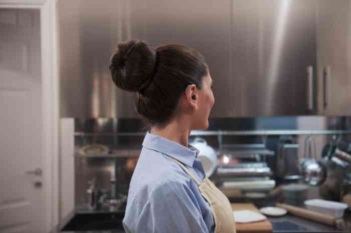 A woman in profile in a kitchen