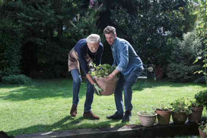 A young man and an elderly man gardening