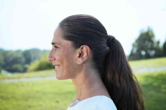 A woman wearing an ITE hearing aid