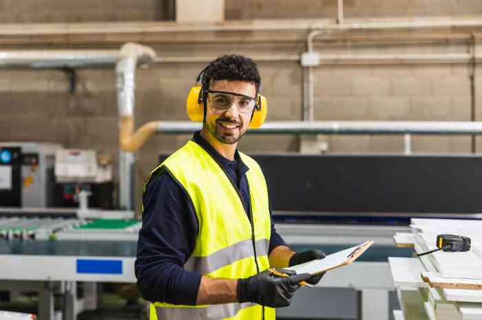 Worker wearing hearing protection in an industrial factory environment