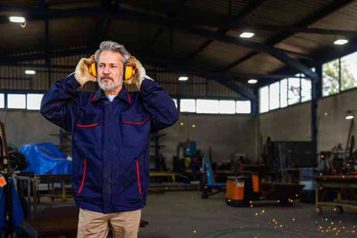 Worker wearing ear protection in a noisy industrial workshop