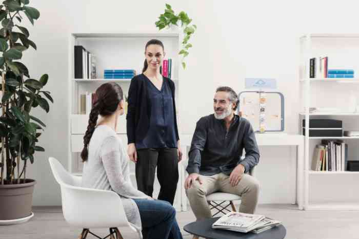 Three people speak at a Bay Audiology center