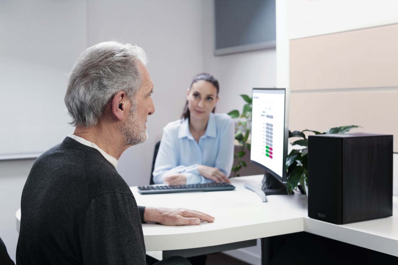 An old man in a consultation with an audiologist