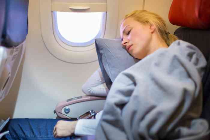 a girl sleeping in an airplane