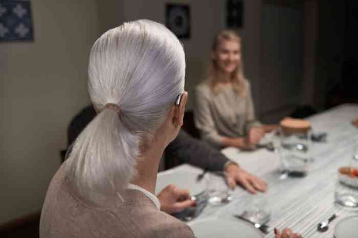 woman with hearing aid at dinner table