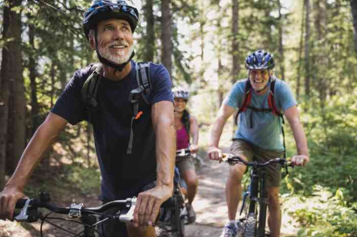 a group of elderly people doing a bike ride in the forest