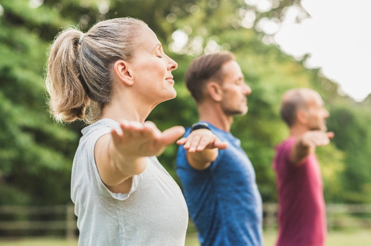 group doing yoga exercise outside