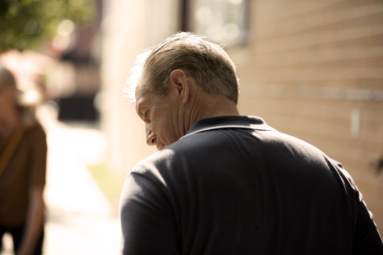 Back of man with hearing aids