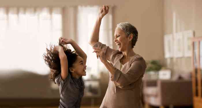 elderly woman and her granddaughter dancing together