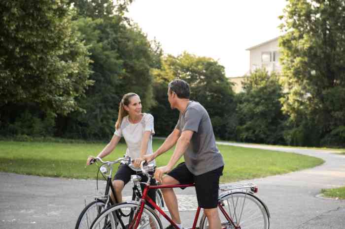 two people talking together on their bycicles