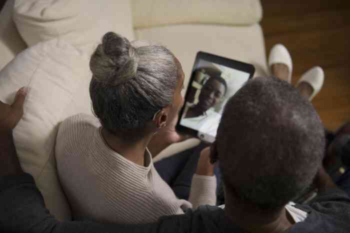 A couple listening to a facetime call straight away in their hearing aids