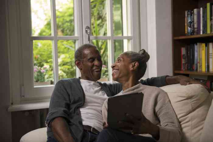 a couple using a tablet together in the living room