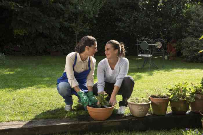 a woman wearing invisible hearing aids gardening with her daughter