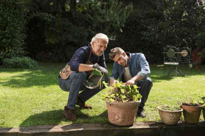 father and son gardening outside