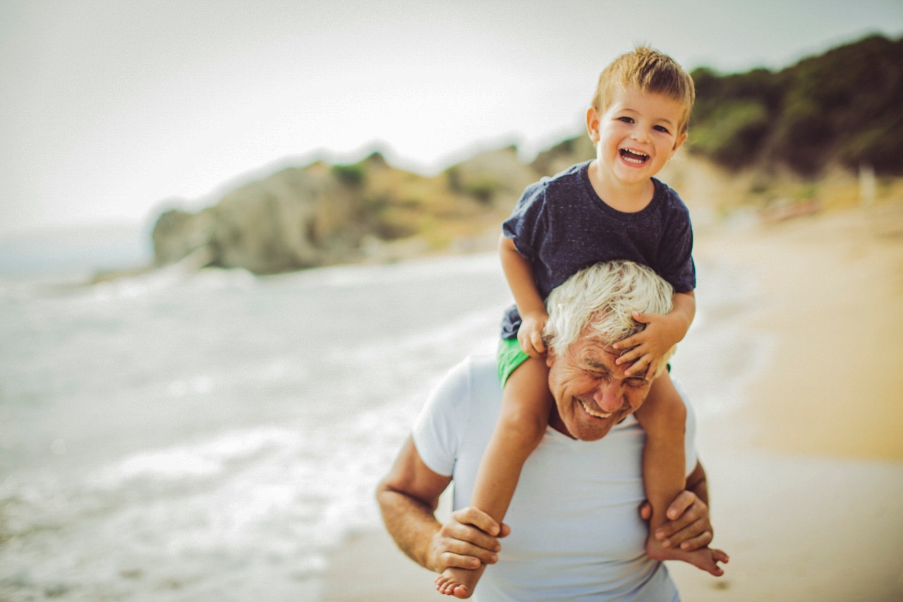Grandfather with grandchild on his shoulder