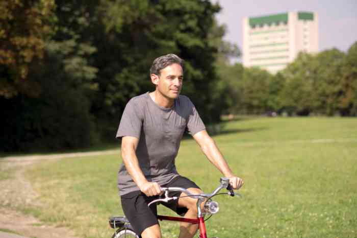a man riding his bicycle in a park