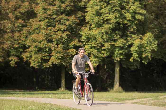 a man going cycling in a park