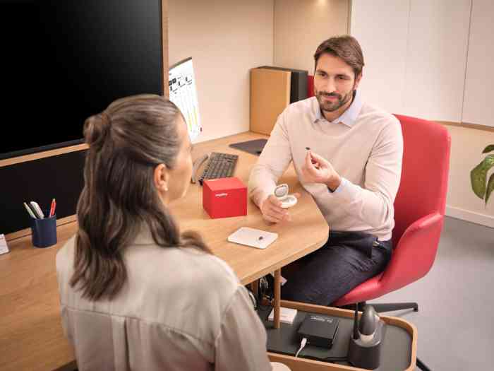 Audiologist showing a hearing aid