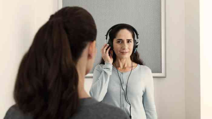 a woman with headphones performing a hearing test