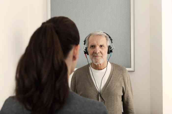 An elderly man undergoing a free hearing check