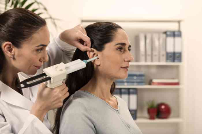 Employee checking a woman's ear