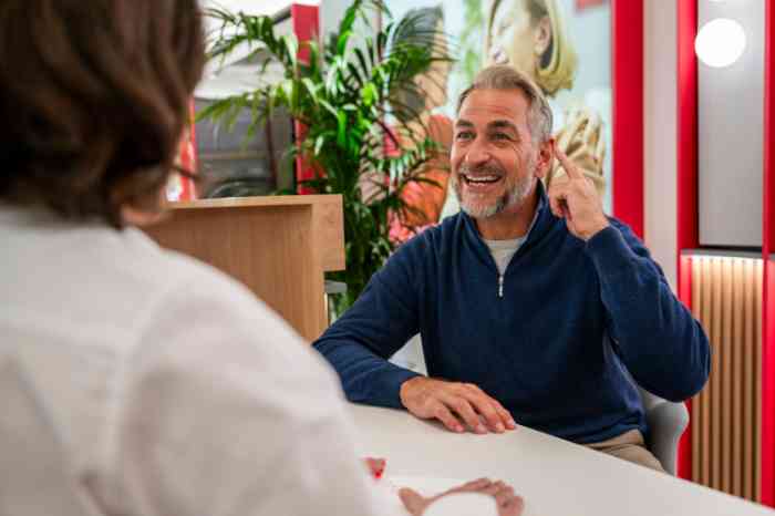 a couple having an appointment in a national hearing care center with a hearing aid specialist