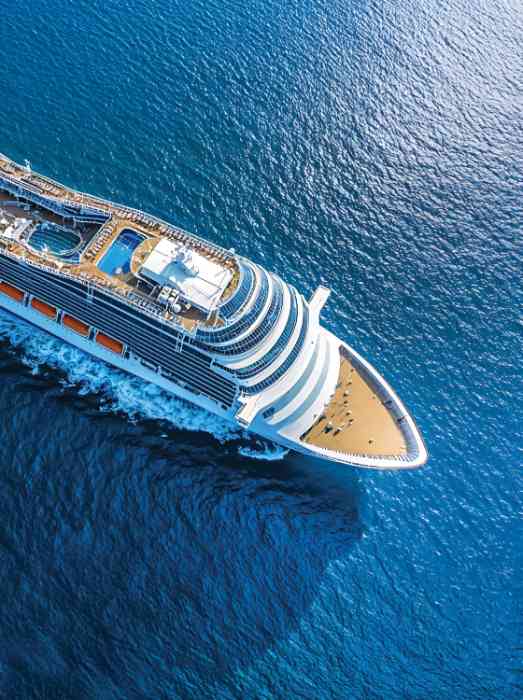 couple on cruise ship looking out at the ocean