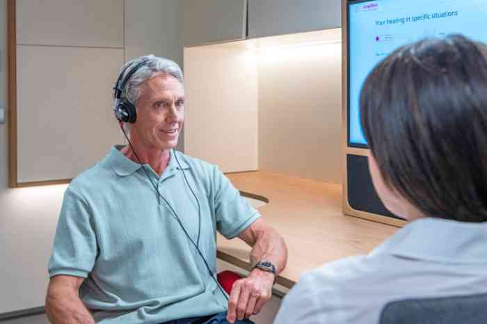 an elderly man doing a hearing test with an audiologist in a national hearing care center