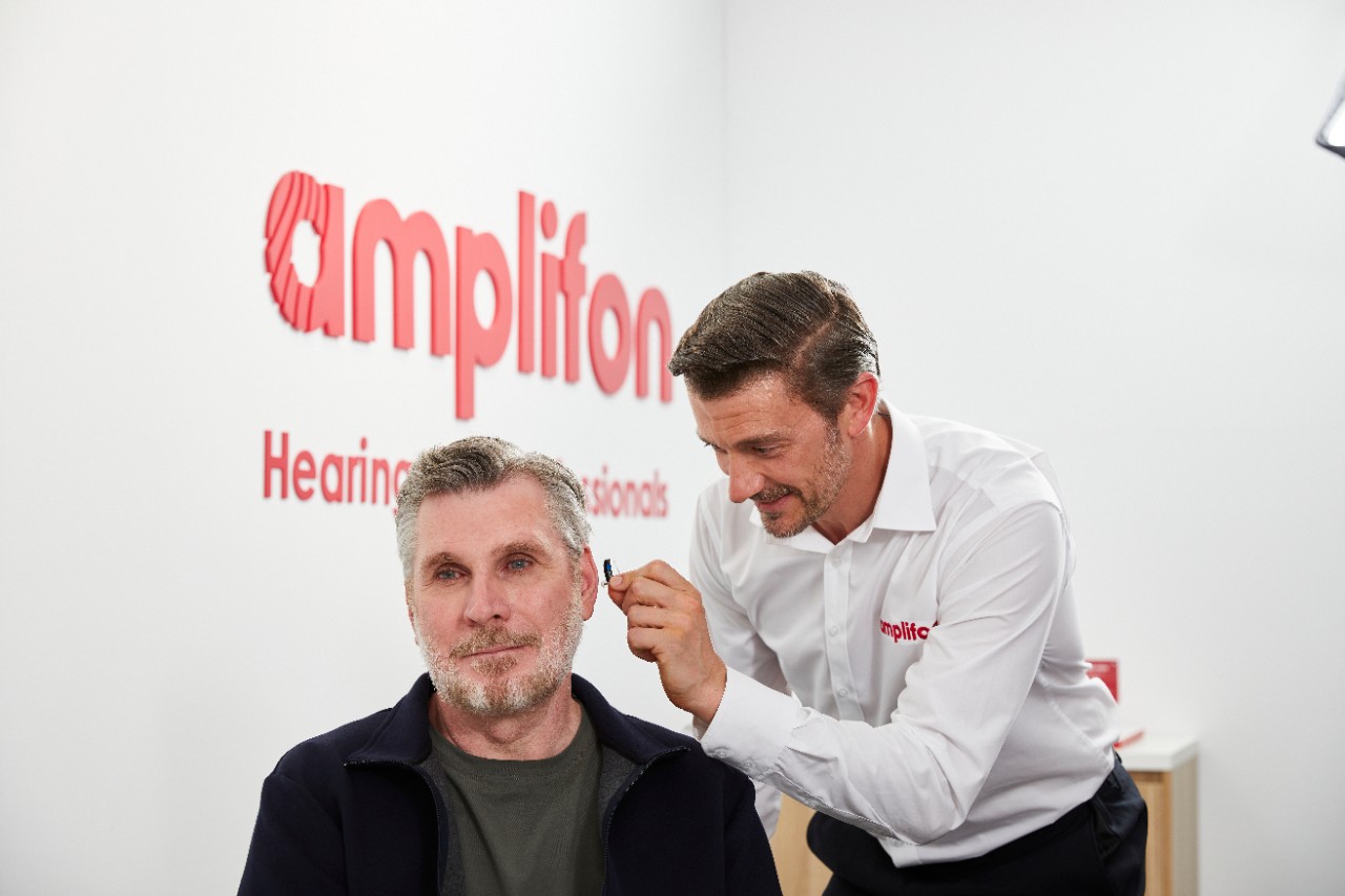 a man taking a hearing test at Amplifon
