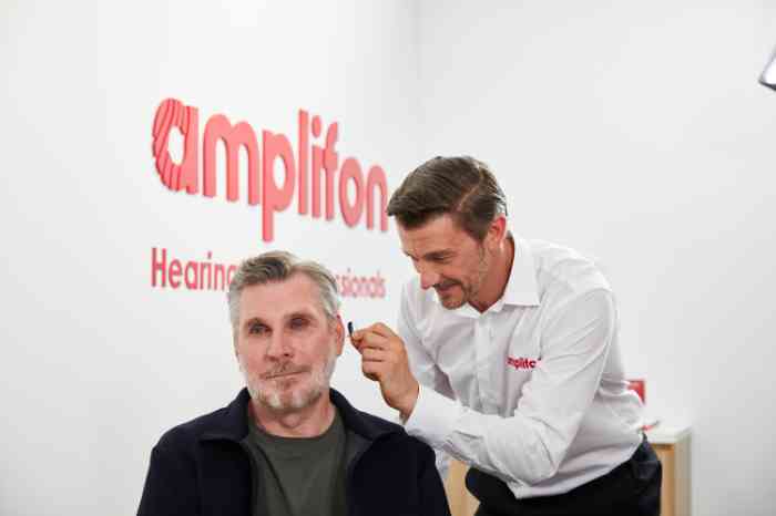 a man taking a hearing test at Amplifon