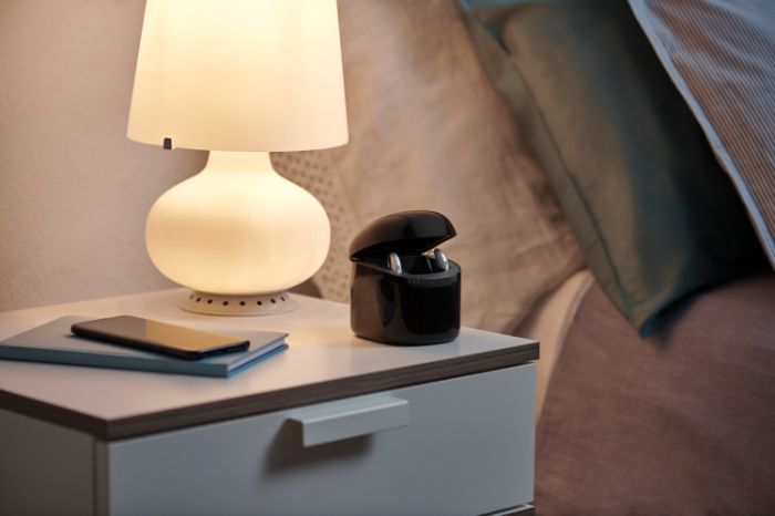 Amplifon hearing aids in the case on the nightstand