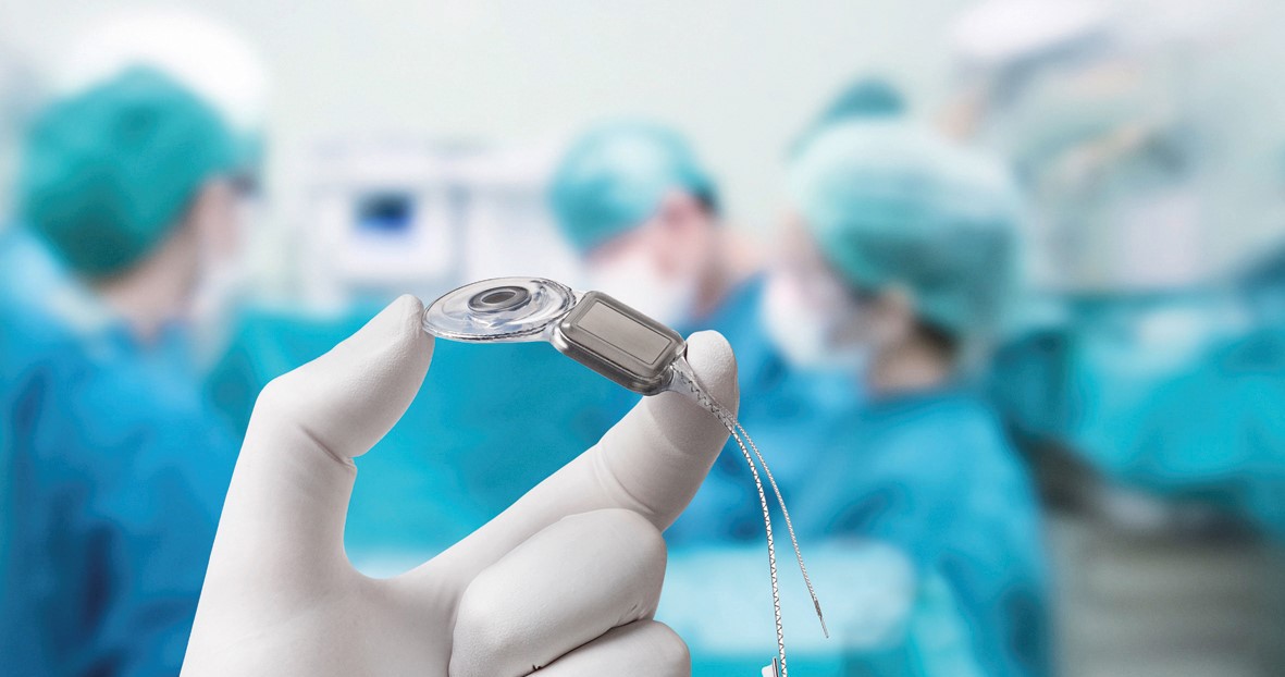 hands holding a hearing aid 