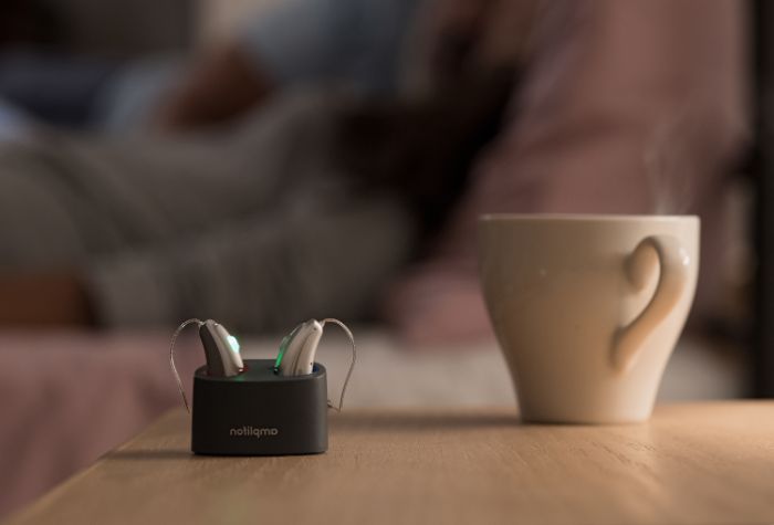 Amplifon hearing aids on the bed side table